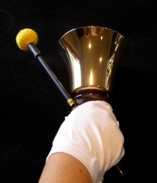 Holding both mallet and bell
