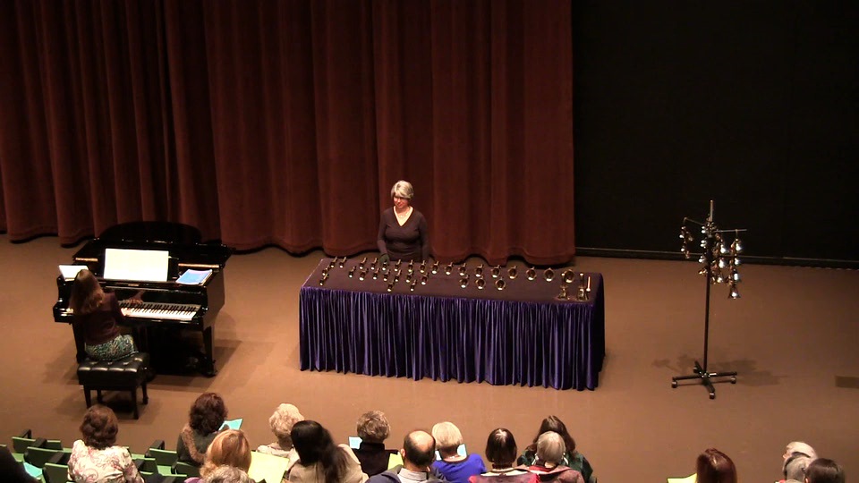 Here you can see the table set with most bells in keyboard order. Some are displaced for the piece. Bell trees hang on a stand (far right). (Seattle Public Library - Microsoft Auditorium) 